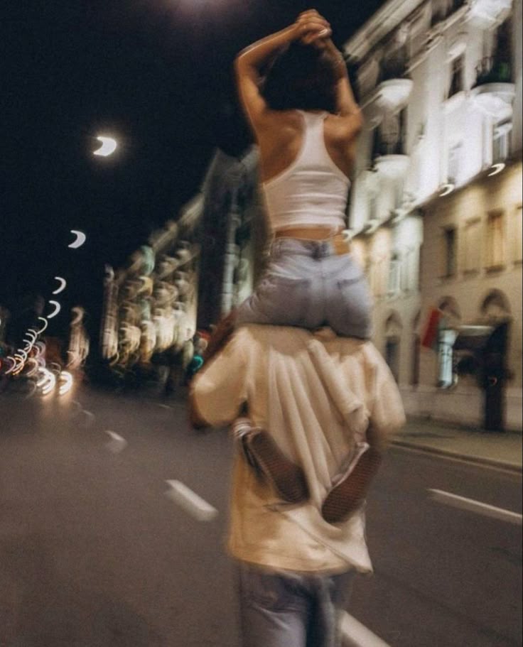 Couple on shoulders at night